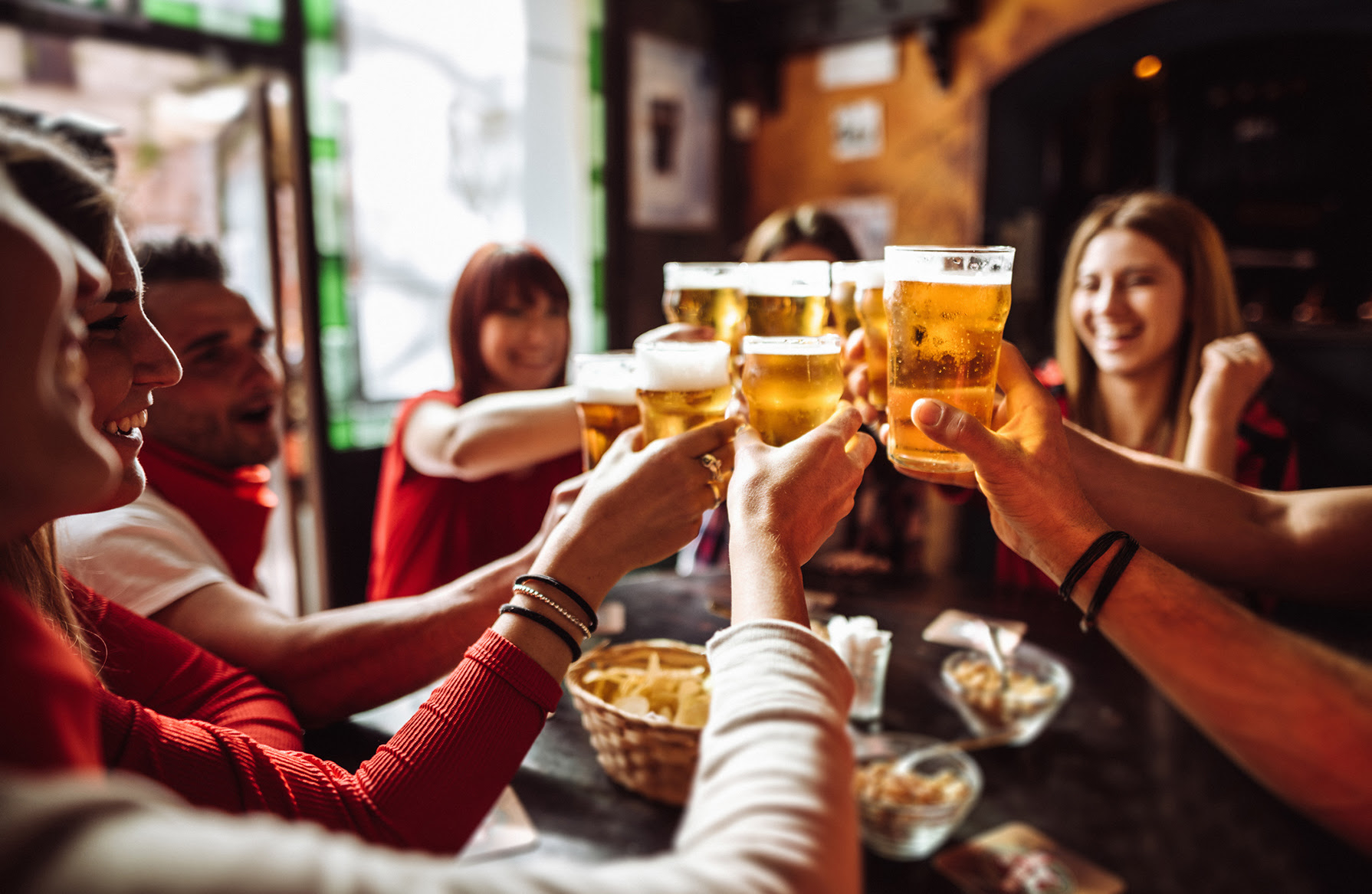 people talking toasting in a pub with the beers